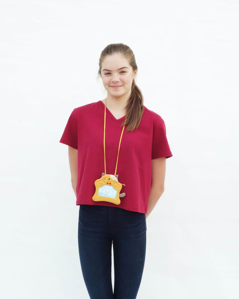 Woman with a golden yellow cat ID card Badge holder with two paws holding the PVC window, a lanyard attached, and a zipper pocket in the back