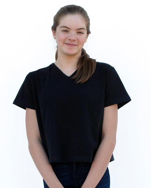 Woman wearing Cat Crop Top in black with V-neck and short sleeves in close-up front view.