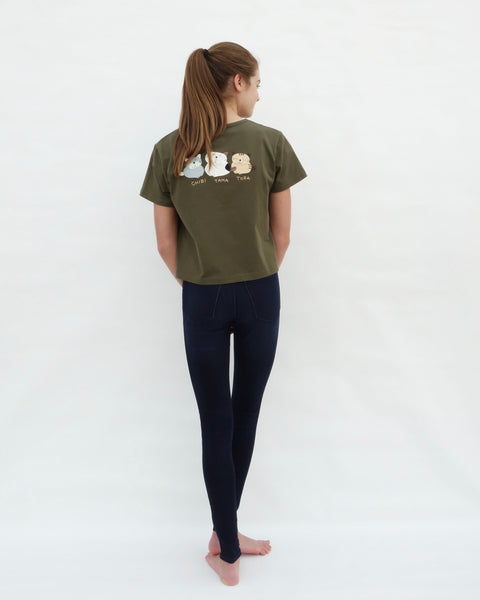 Woman wearing olive green Cat Crop Top with three cat appliqué, embroidery details, V-neck and short sleeves in full-body, close-up back view.