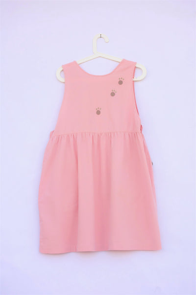 pink sleeveless cat dress with paw prints, buttons on each side