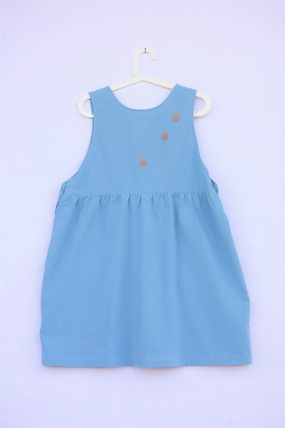 Cute sleeveless blue cat dress with cat paw prints on the back of the dress.