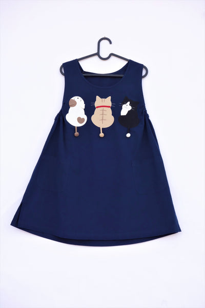 A cat-themed, cotton, dark-blue navy shirt/mini A-line dress/top/tunic on a hanger with three appliqué cats on the front 