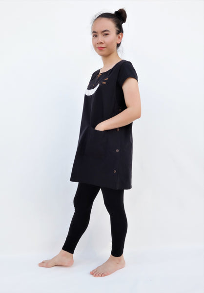 Cat Dress, AKA pinafore dress, in black with cat appliqué, embroidery cat features, button enclosures down the left side in side view.