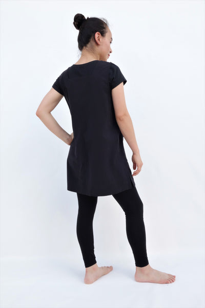 Cat Dress, AKA pinafore dress, in black with button enclosures down the left side in 3/4 back view.