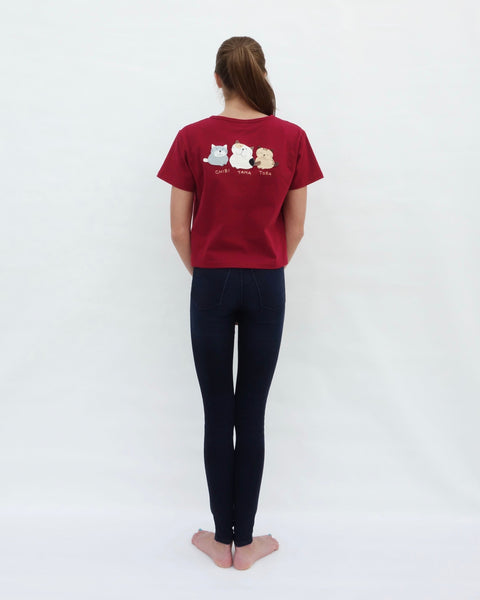 Woman wearing Cat Crop Top in red with three cat appliqué, embroidery details, V-neck and short sleeves in full-body, close-up back view.