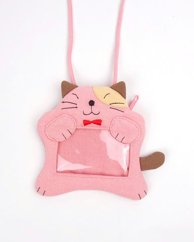 A pink cat ID card Badge holder with two paws holding the PVC window, a lanyard attached, and a zipper pocket in the back 
