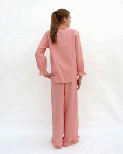 Tall women wearing pink pajamas with cat appliqué, embroidery details, and matching slippers in back view.