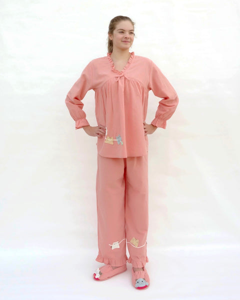Tall women wearing pink pajamas with cat appliqué, embroidery details, and matching slippers in front view.