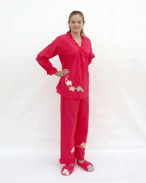 Women wearing red pajamas with cat appliqué, embroidery details, and matching slippers in 3/4 view.