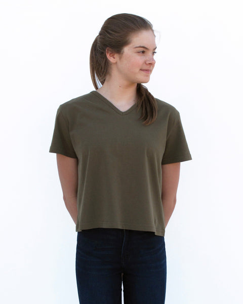Woman wearing olive green, Cat Crop Top with V-neck and short sleeves in close-up front view.