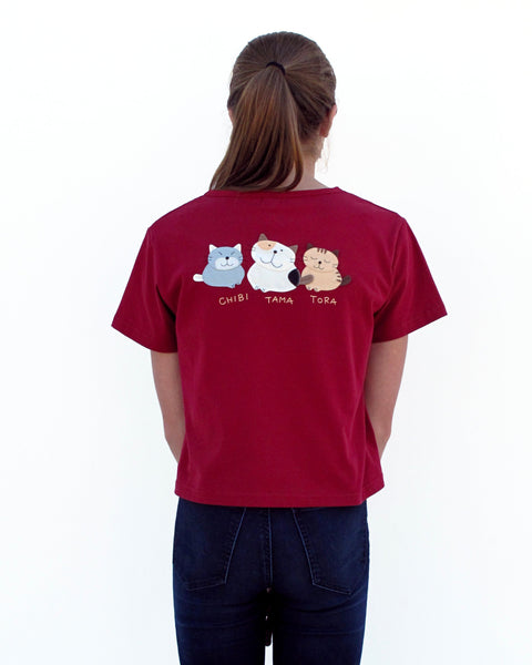 Woman wearing Cat Crop Top in red with three cat appliqué, embroidery details, V-neck and short sleeves in close-up back view.