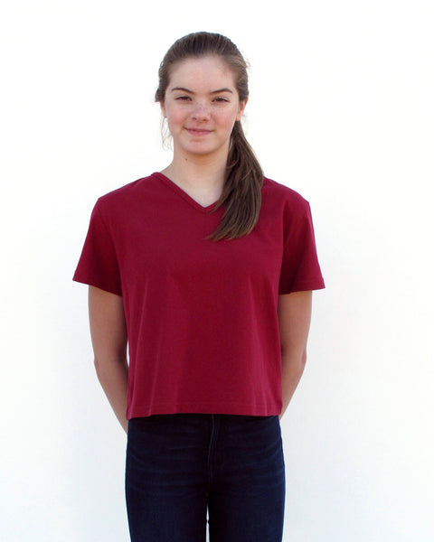 Woman wearing Cat Crop Top in red with V-neck and short sleeves in close-up front view.