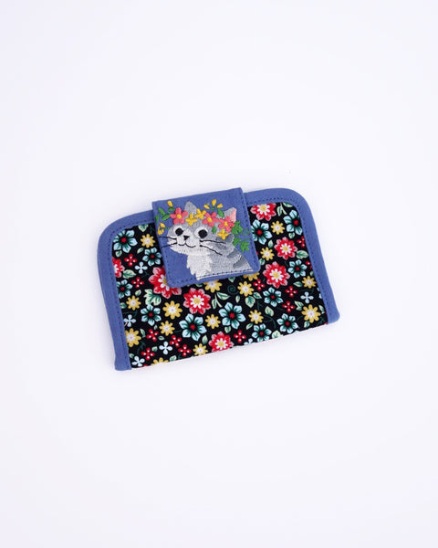 Cat Card-Case in blue blossoms with cat appliqué, embroidery detail and Velcro flap closure in front view.