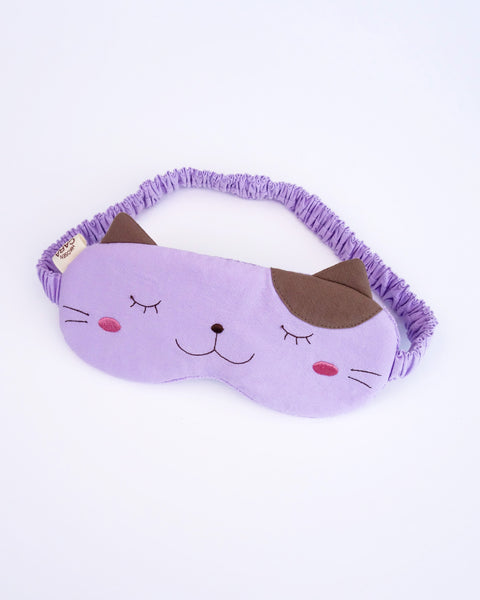 Cat eye mask in lilac color with appliqué, embroidery, 3D cat ears, elastic strap, foam-padding, in front view.