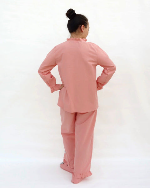 Women wearing pink pajamas with cat appliqué, embroidery details, and matching slippers in back view.
