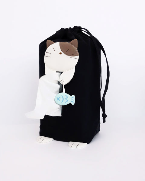 Cat tissue box cover in black with drawstrings, two hanging straps, cat appliqué, fish charm, and cat feet, in front view.