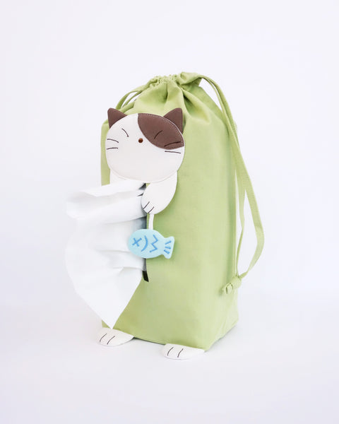 Cat tissue box cover in green with drawstrings, two hanging straps, cat appliqué, fish charm, and cat feet, in front view.
