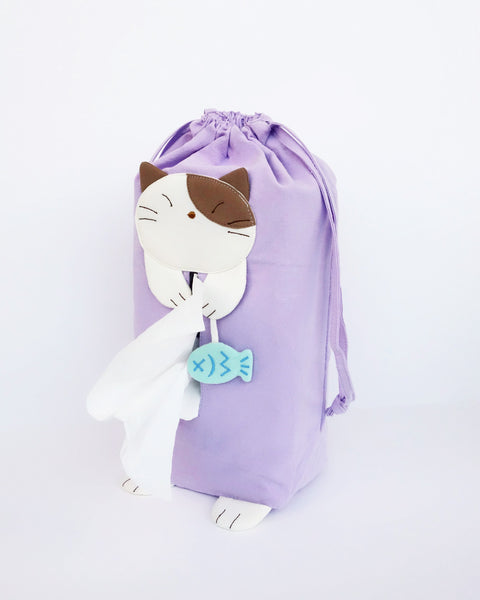 Cat tissue box cover in lilac with drawstrings, two hanging straps, cat appliqué, fish charm, and cat feet, in front view.